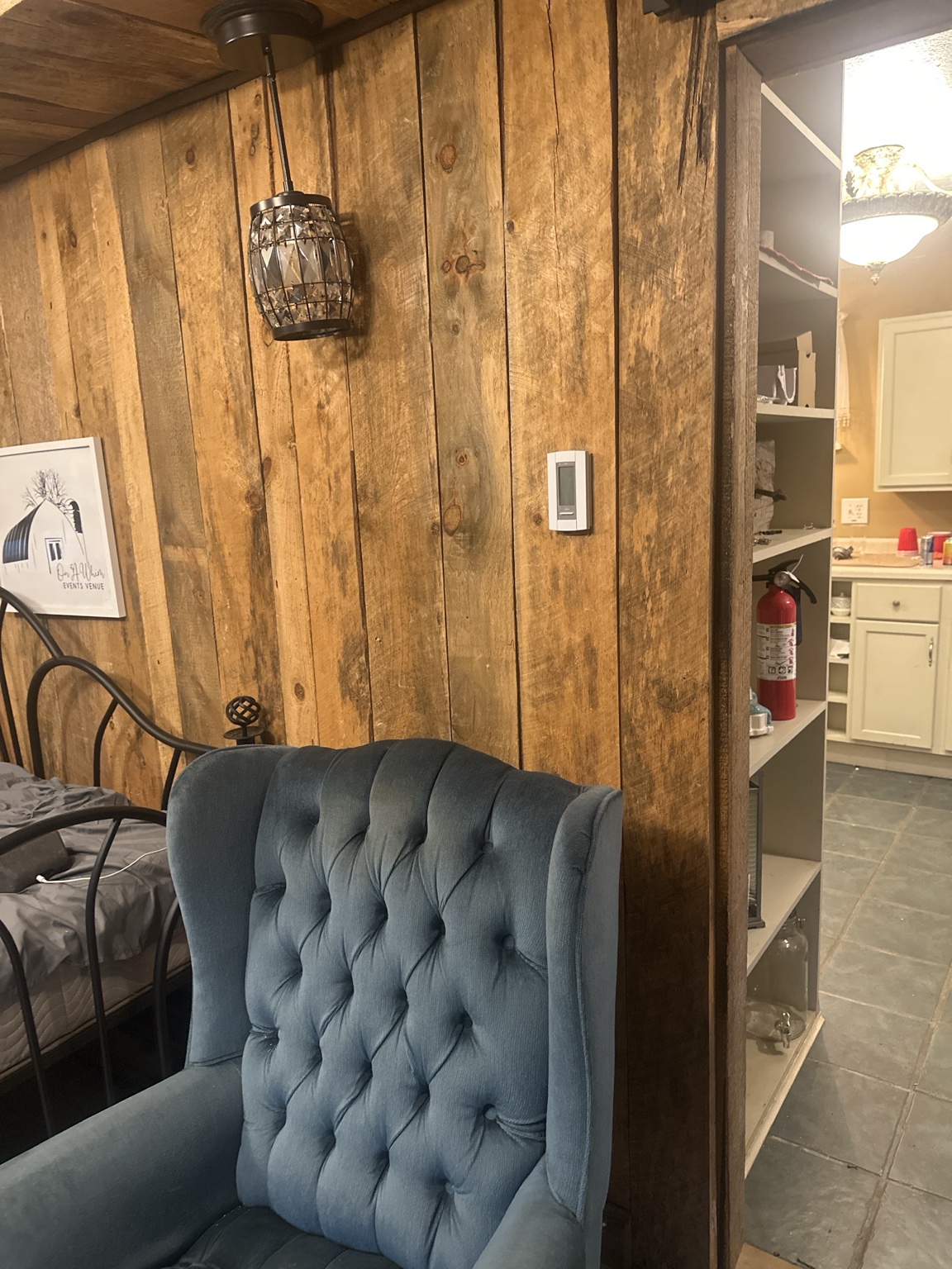 Cozy blue chair beside rustic wood walls inside the property