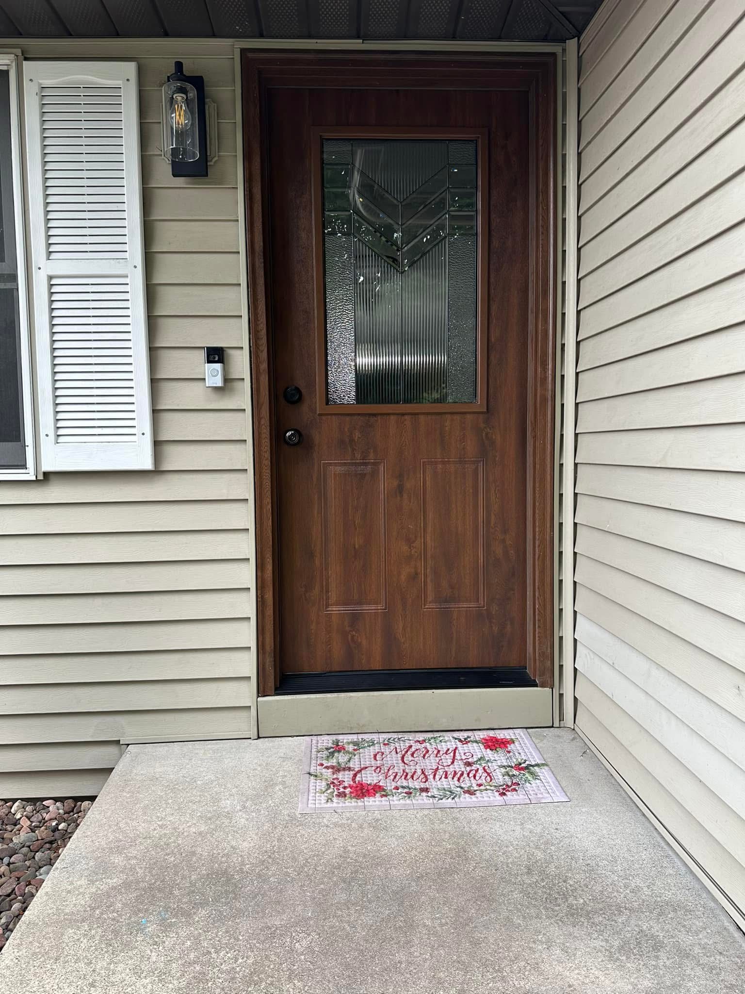 Completed wood-look front entry door installed by Rustic Memories