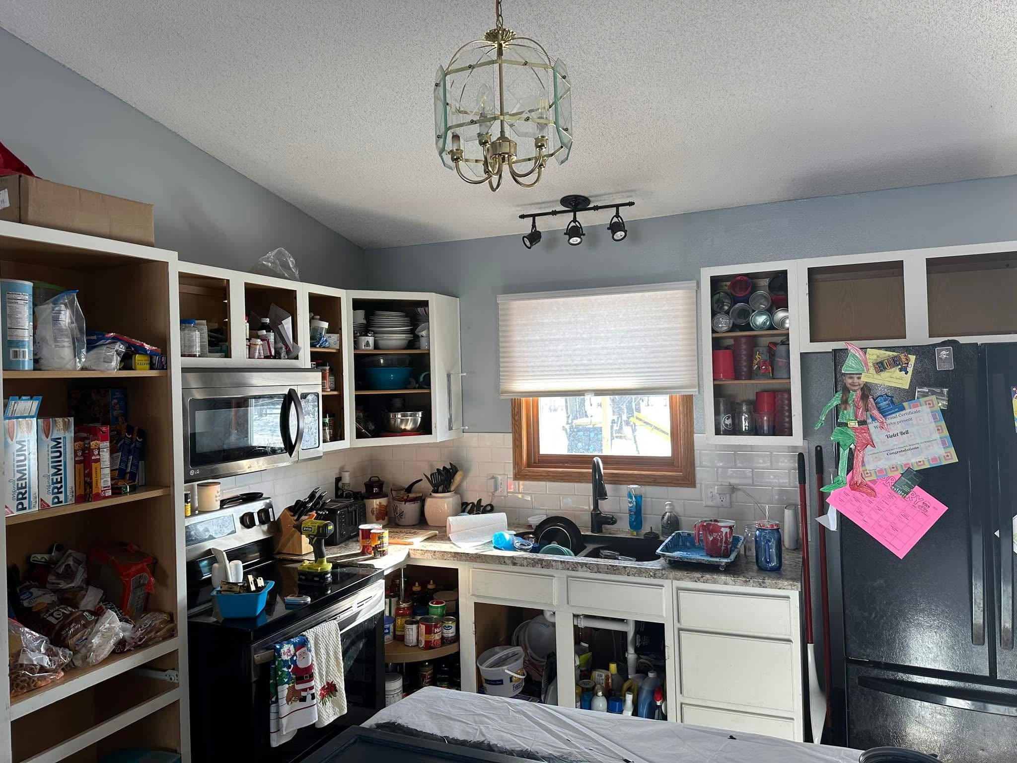 Kitchen cabinets with doors removed during a Rustic Memories refinishing project