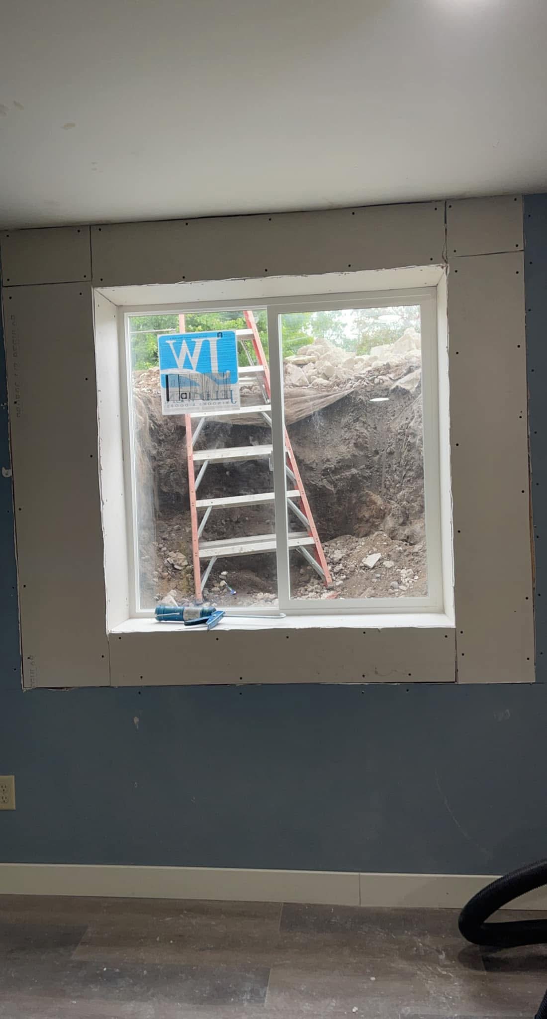 Replacement window installed with drywall fitted around the opening