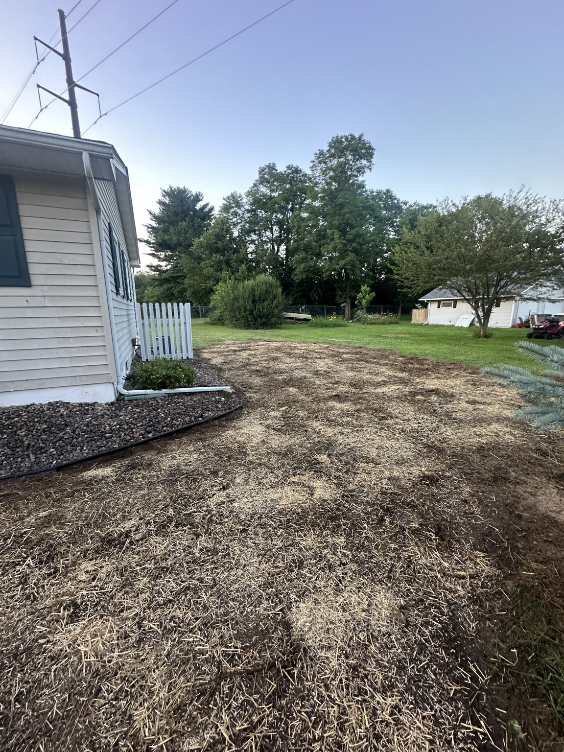 Residential lawn area prepared with seed and straw after grading