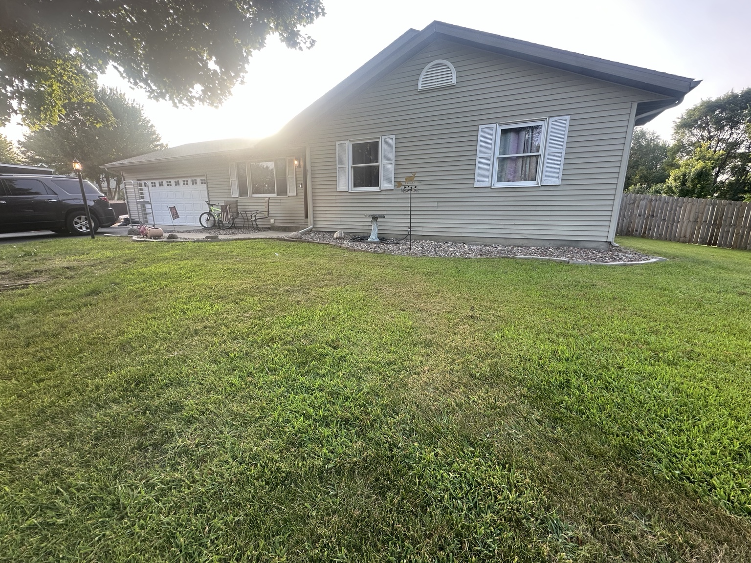 Clean finished residential yard with trimmed lawn and maintained beds