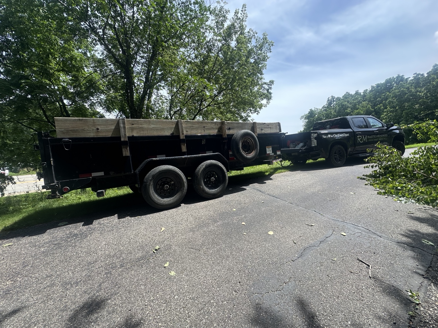 Rustic Memories truck and dump trailer positioned for tree debris removal